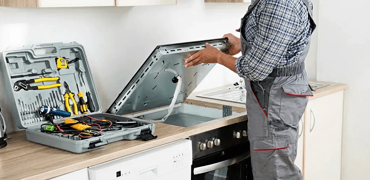 Handyman repairing a cooktop and checking wiring connections in Richmond, VA