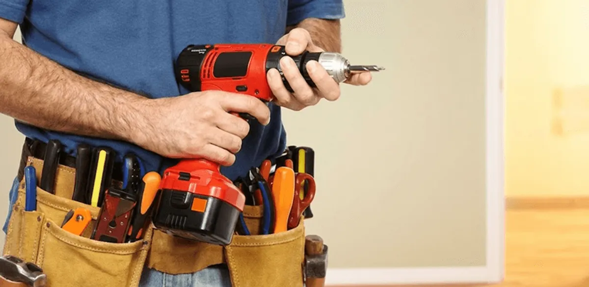 Handyman holding a power drill for home repairs and installations in Richmond, VA